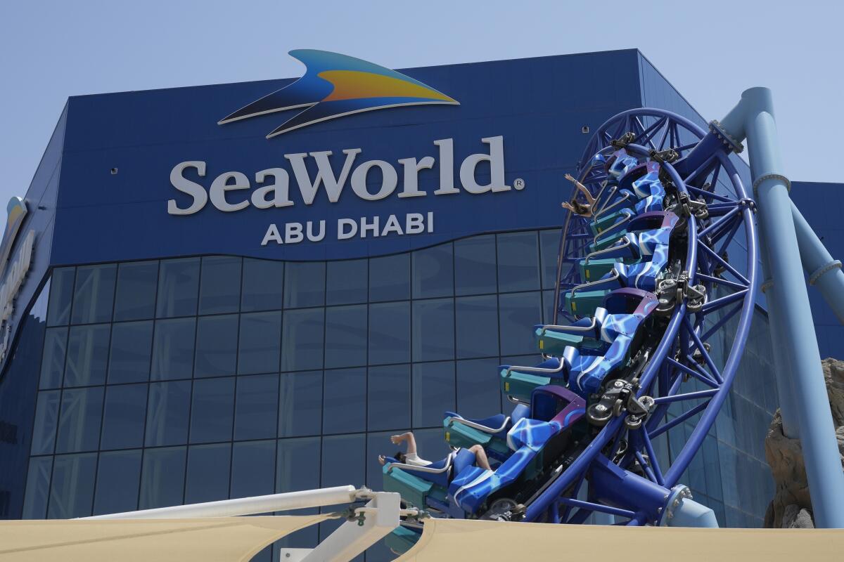 People enjoy riding on a roller coaster at the SeaWorld on Yas Island in Abu Dhabi, United Arab Emirates.