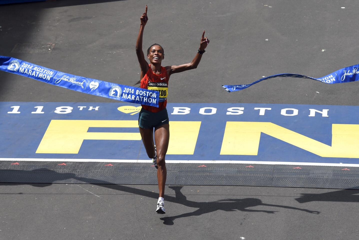 Rita Jeptoo, of Kenya, crosses the finish line to win the Women's Elite division of the 118th Boston Marathon in Boston, Massachusetts.