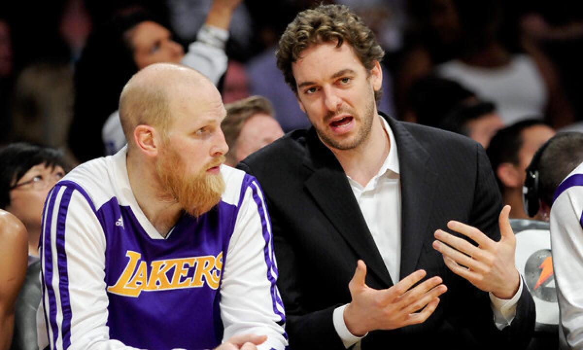 Chris Kaman, left, and Pau Gasol had plenty of time to catch up on the bench during the Lakers' 115-99 win over the Phoenix Suns on March 30.