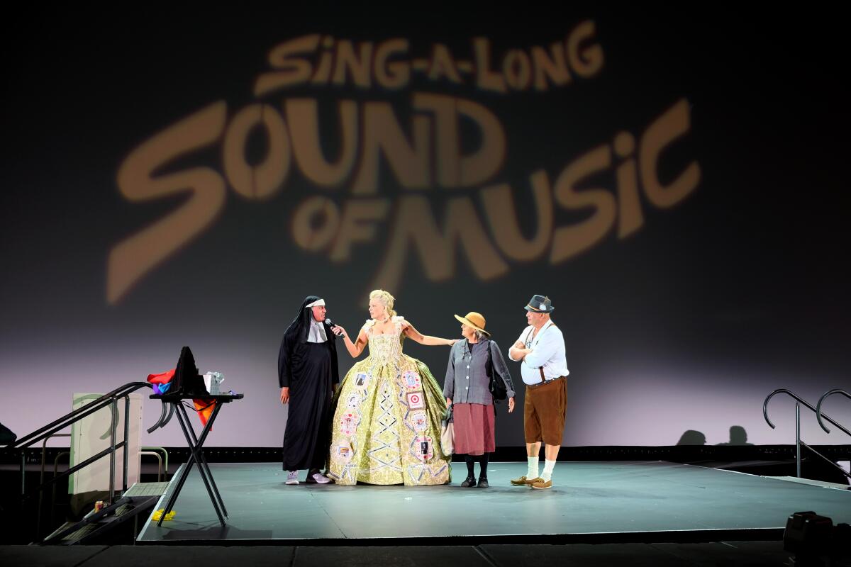 A group of actors sing onstage.