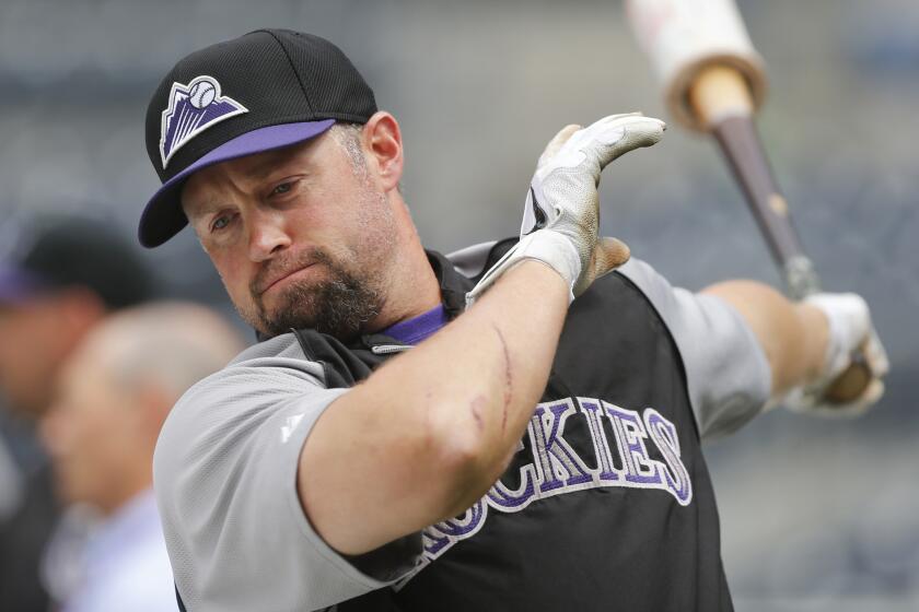 Colorado Rockies outfielder Michael Cuddyer warms up for batting practice prior to the start of a game against the San Diego Padres on Thursday.