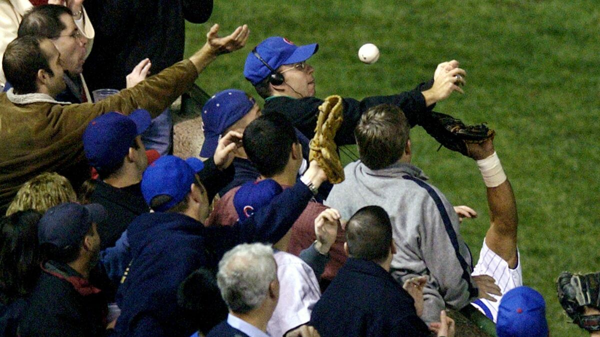 Cubs fan Steve Bartman prevents outfielder Moises Alou from catching a foul ball during Game 6 of the 2003 NLCS.