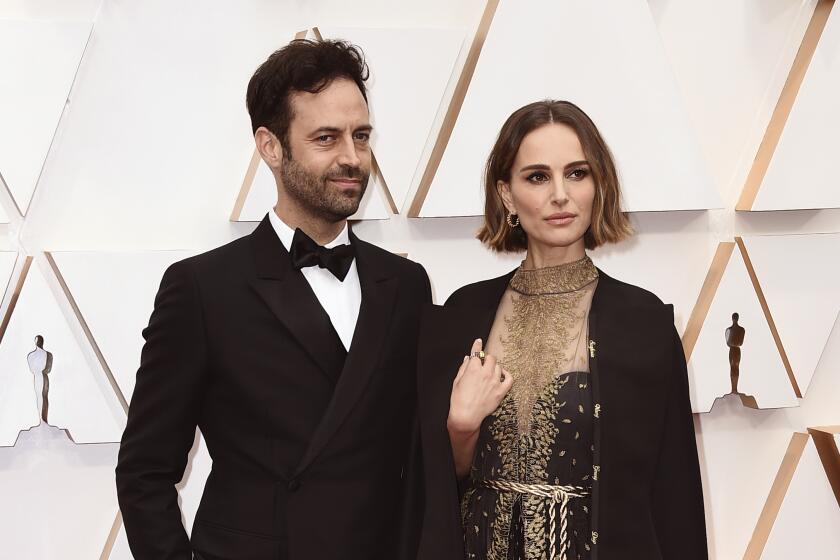 FILE - Benjamin Millepied, left, and Natalie Portman appear at the Oscars in Los Angeles on Feb. 9, 2020. Portman and Millepied have divorced after 11 years of marriage and two children. The Oscar-winning actor and Millepied, a choreographer and director, finalized the divorce last month in France. (Photo by Jordan Strauss/Invision/AP, File)