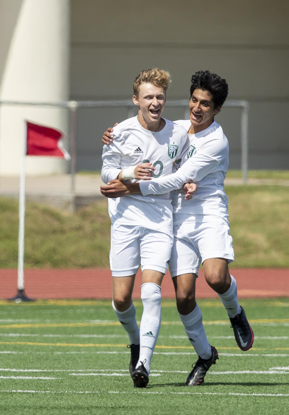Edison's Kevin Blanco, right, congratulates Trent Bellinger after Bellinger scored a goal against Fountain Valley.