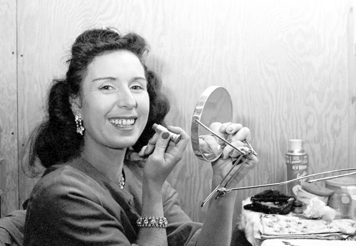 Jenny Wallenda, a member of the famous Wallenda high-wire act, applies makeup in a dressing room before a performance in 1964.
