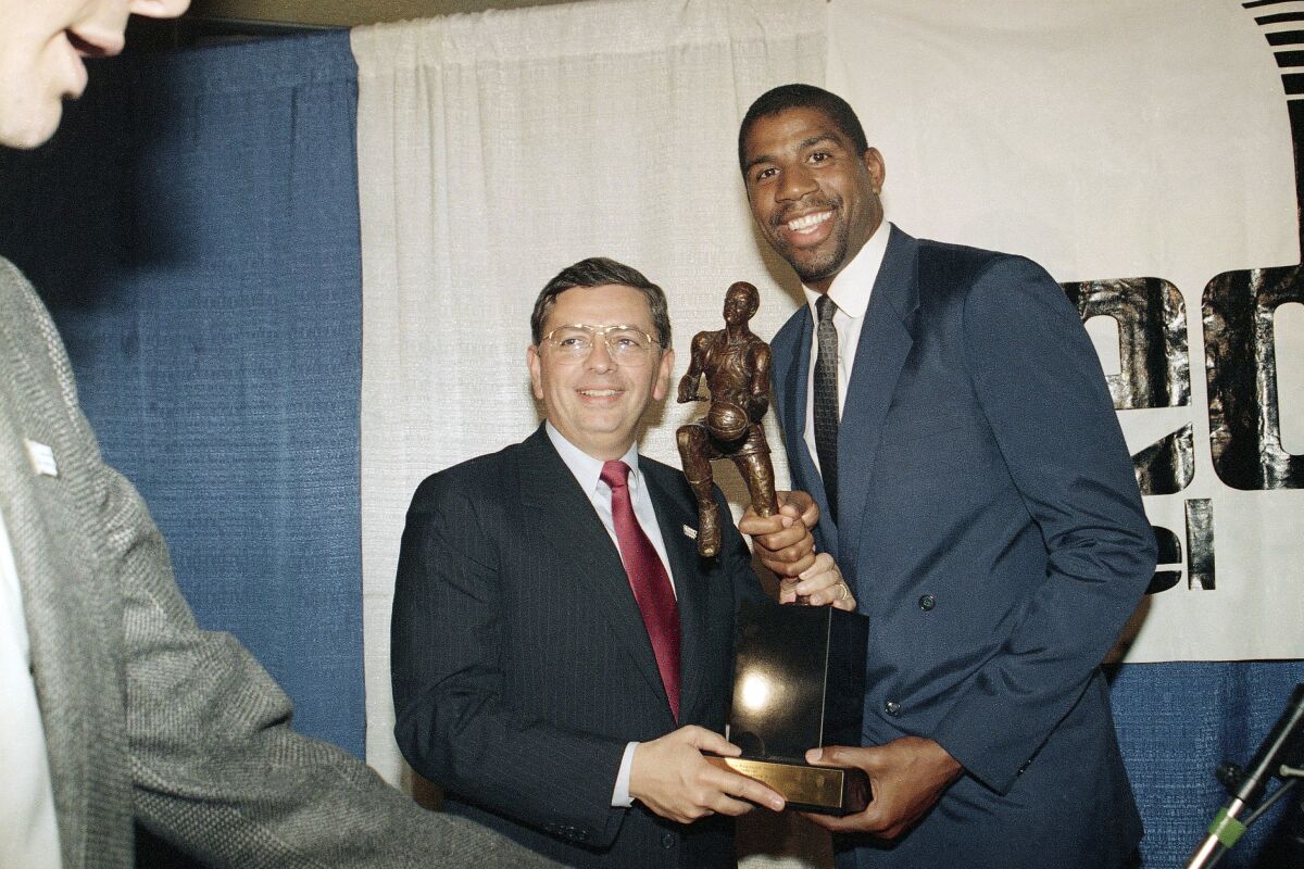 FILE - Earvin "Magic" Johnson breaks stands with David Stern, commissioner of the National Basketball Association, May 18, 1987, at the Forum in Inglewood, Calif., after Johnson was named the NBA's Most Valuable Player for 1986-87 season. (AP Photo/Alison Wise, File)