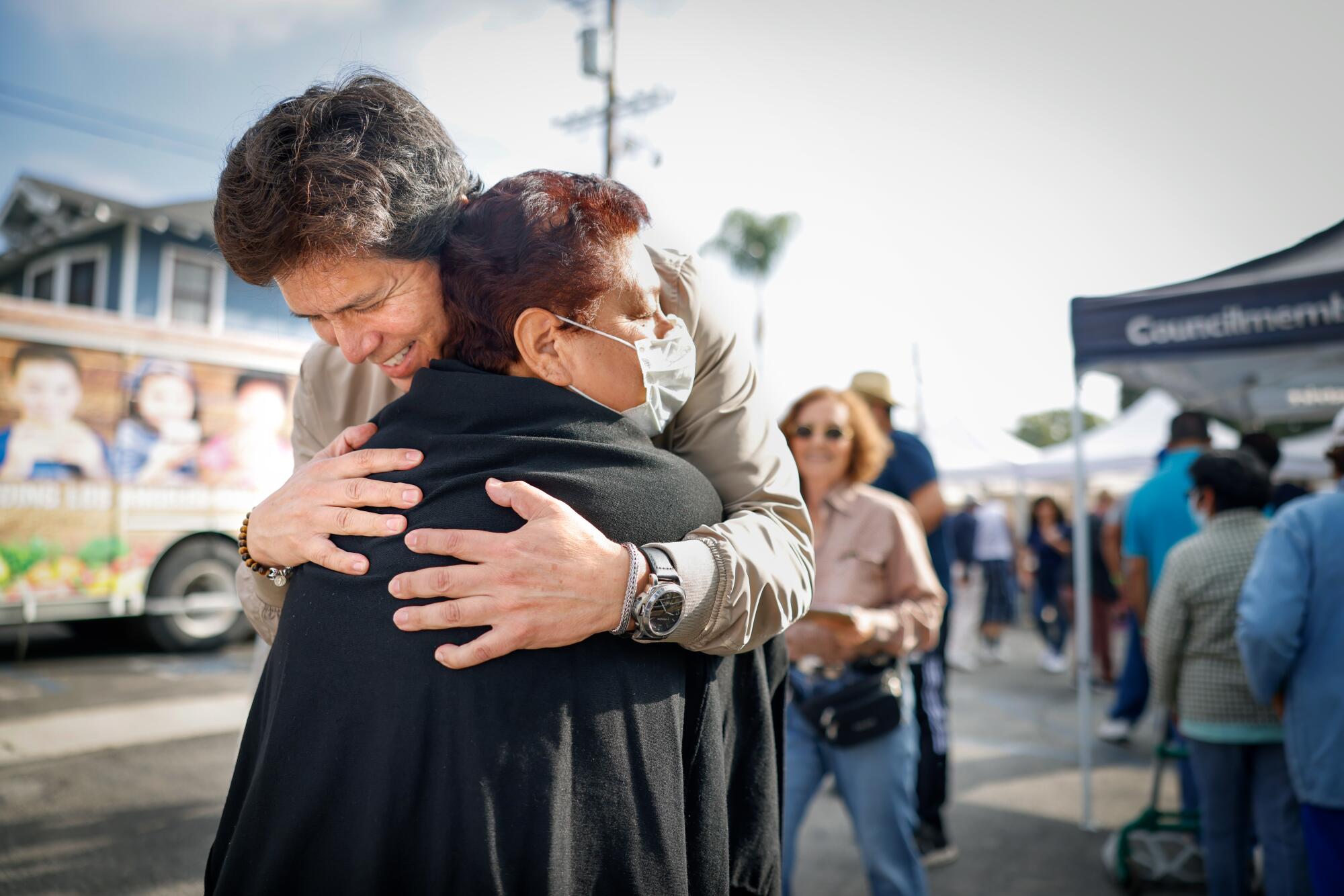 Councilman Kevin De León hugs a person