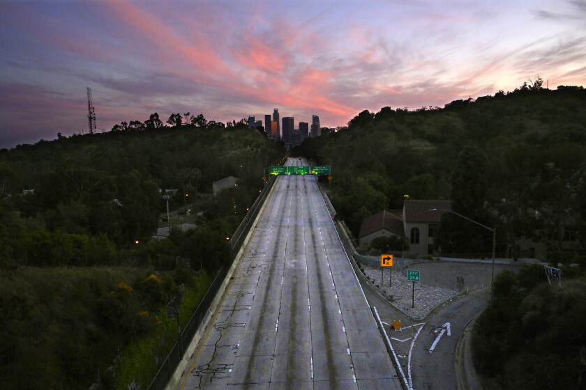 South bound lanes of the 110 Arroyo Seco Parkway leading to downtown Los Angeles are empty during the coronavirus outbreak. At the peak of the pandemic shutdown, global daily carbon dioxide emissions were down 17%, according to a new study.