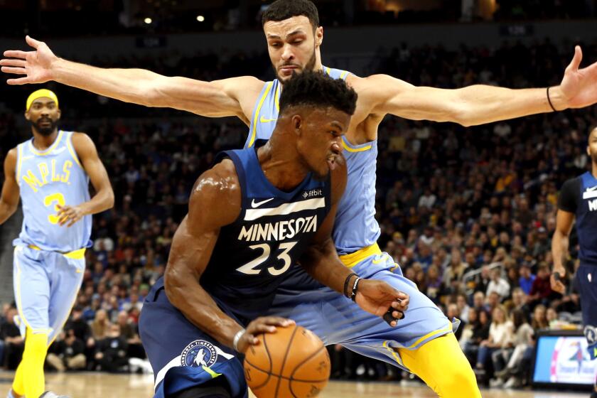 Minnesota Timberwolves' Jimmy Butler, left, drives around Los Angeles Lakers' Josh Hart in the first half of an NBA basketball game Monday, Jan. 1, 2018, in Minneapolis. (AP Photo/Jim Mone)