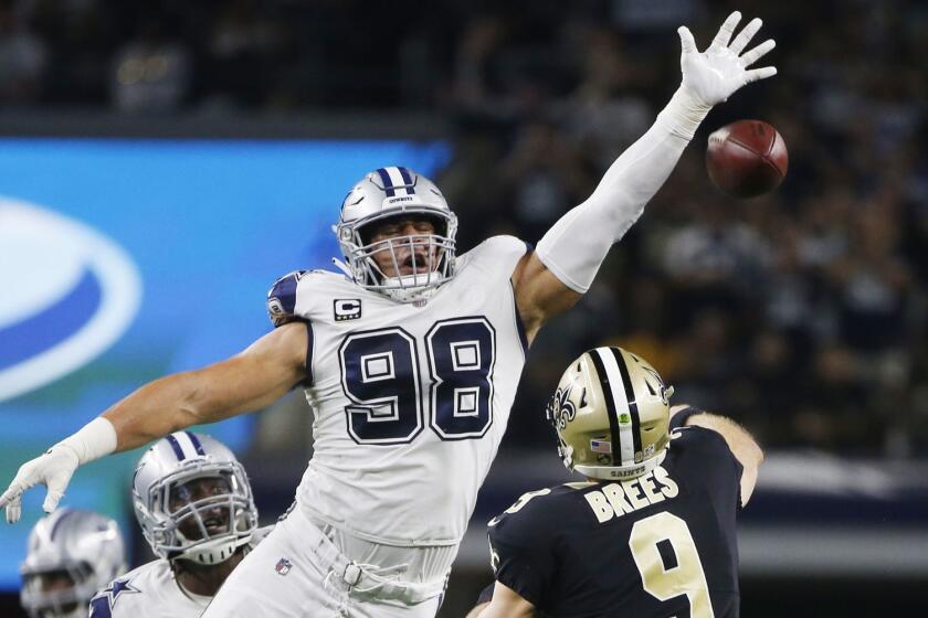 New Orleans Saints quarterback Drew Brees (9) is pressured by Dallas Cowboys defensive tackle Tyrone Crawford (98) as he passes during the second half of an NFL football game, in Arlington, Texas, Thursday, Nov. 29, 2018. (AP Photo/Ron Jenkins)