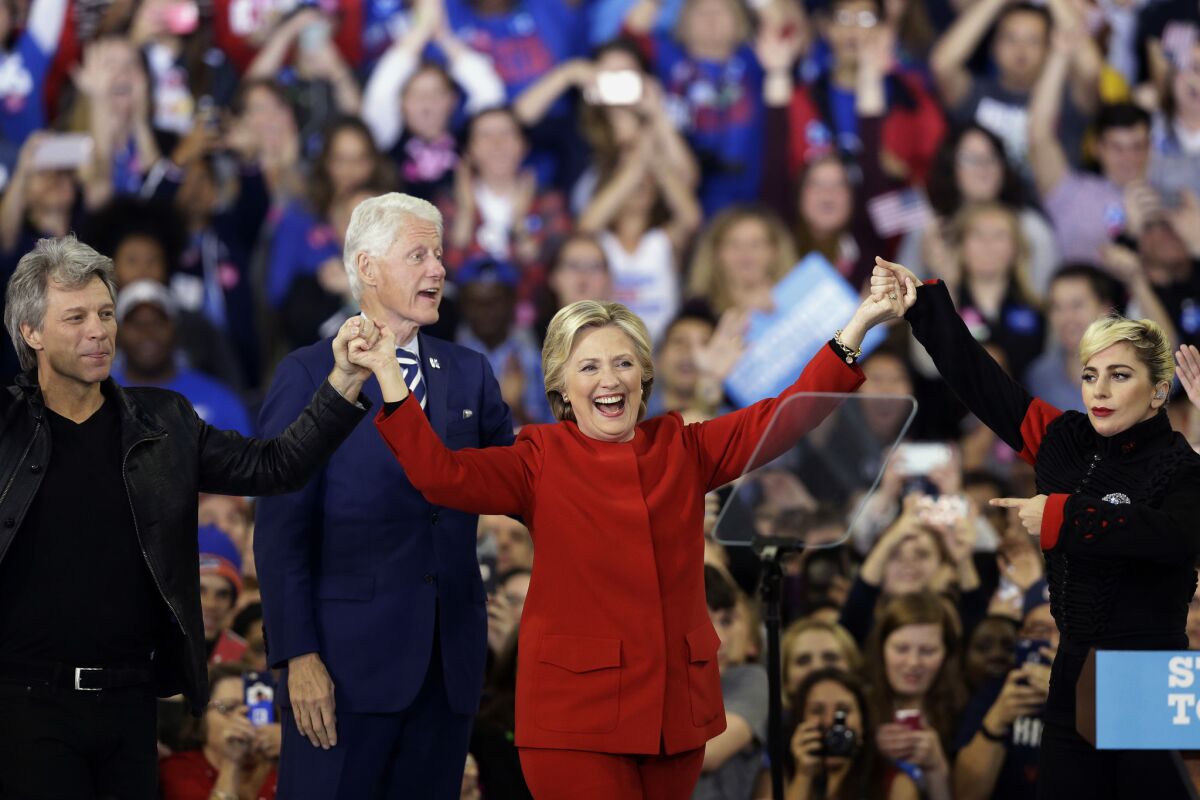 Hillary Clinton is shown  with Jon Bon Jovi, left, Lady Gaga, right, and Bill Clinton.
