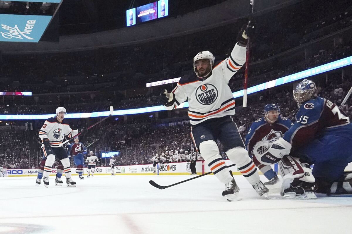 Edmonton Oilers left wing Evander Kane (91) celebrates a goal against Colorado Avalanche goaltender Darcy Kuemper (35) during the first period in Game 1 of the NHL hockey Stanley Cup playoffs Western Conference finals Tuesday, May 31, 2022, in Denver. (AP Photo/Jack Dempsey)
