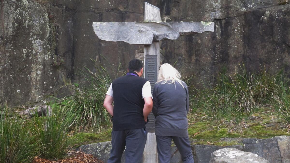 Tourists reads the names of victims killed at Port Arthur, the worst mass shooting in Australia's history. The event prompted lawmakers to institute strict gun control laws.