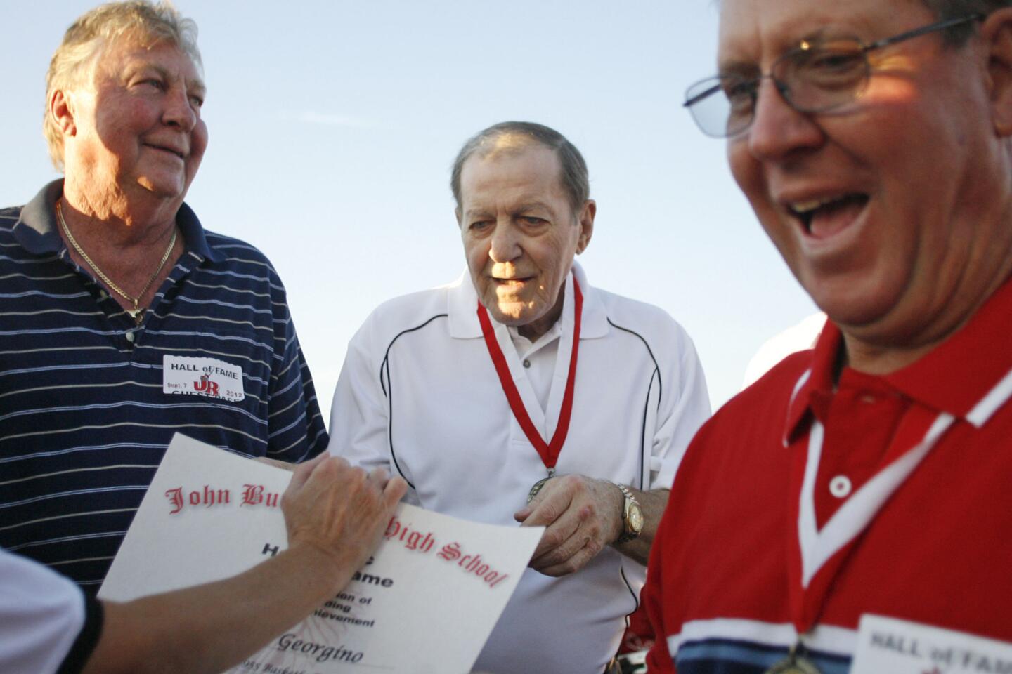 Inductee Terry Arnold, center, is honored into the Hall of Fame at John Burroughs High School in Burbank on Friday, September 7, 2012.