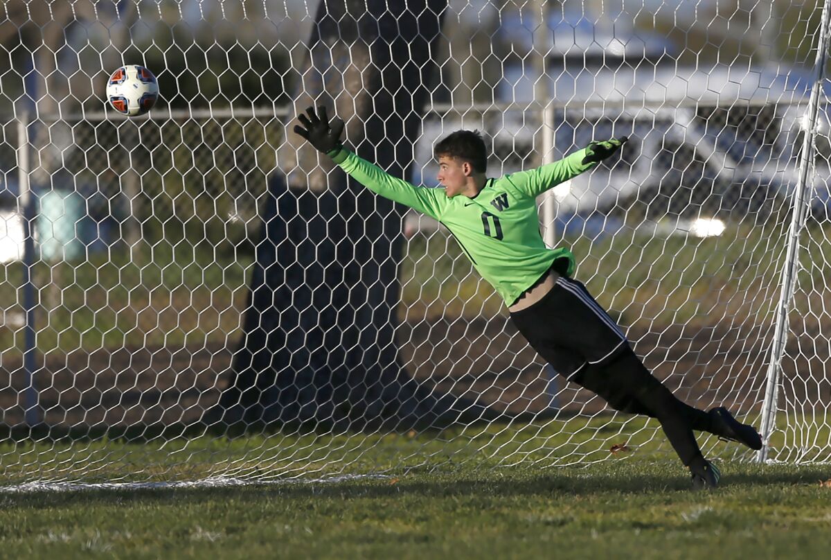 Waldorf School goalkeeper Max Schwartz tips a shot wide for a save against Rancho Alamitos in Costa Mesa on Tuesday.