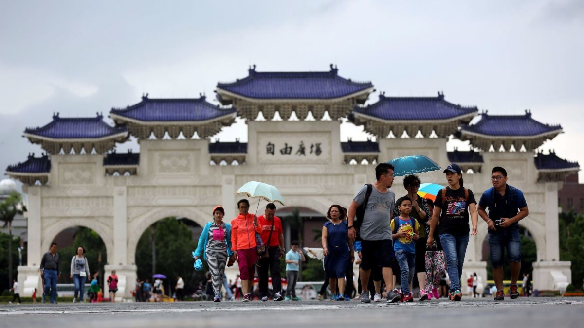 Chinese tourists walk outside the Chiang Kai-shek memorial hall in Taipei, Taiwan, on April 19, 2017. (Ritchie B. Tongo / European Pressphoto Agency)