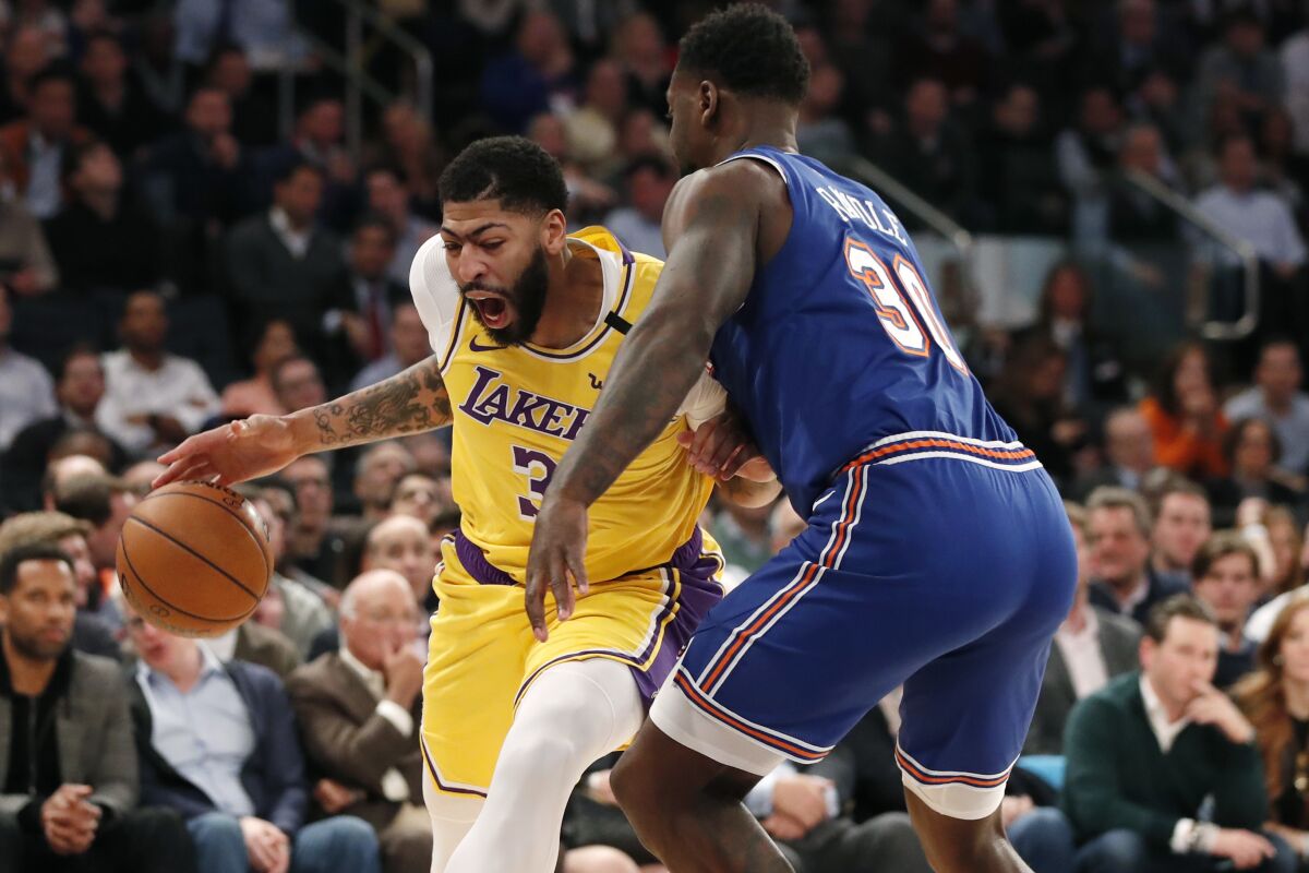 Lakers forward Anthony Davis drives against Knicks forward Julius Randle during the first half of a game Jan. 22, 2020, in New York.