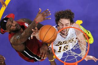 Miami Heat forward LeBron James, left, and Los Angeles Lakers power forward Pau Gasol of Spain reach for a rebound during the first half of their NBA basketball game, Saturday, Dec. 25, 2010, in Los Angeles. The Heat won 96-80. (AP Photo/Mark J. Terrill)