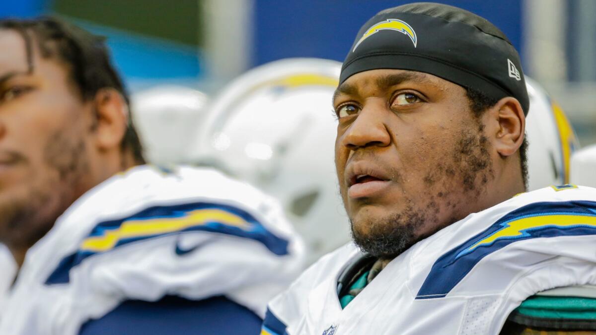King Dunlap sits on the Chargers' bench during a Dec. 11 game against the Carolina Panthers.