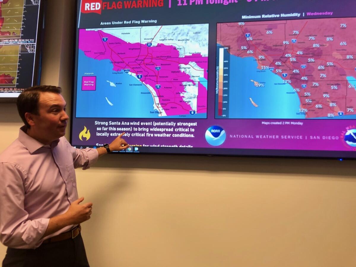 Brian D'Agostino, director of fire science and climate adaptation at San Diego Gas & Electric, points to a map showing a Red Flag Warning is in effect for the San Diego area through Thursday night.