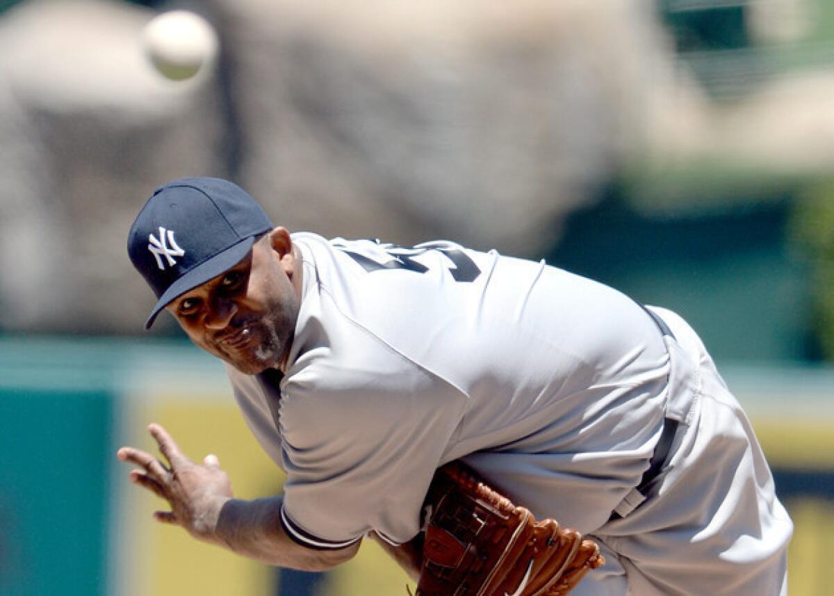 New York Yankees' CC Sabathia delivers against the Angels in the second inning at Angel Stadium.
