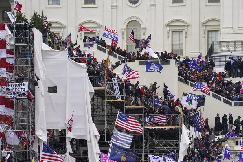 FILE - In this Jan. 6, 2021, file photo rioters loyal to President Donald Trump storm the U.S. Capitol in Washington. Arguments begin Tuesday, Feb. 9, in the impeachment trial of Donald Trump on allegations that he incited the violent mob that stormed the U.S. Capitol on Jan. 6. (AP Photo/John Minchillo, File)