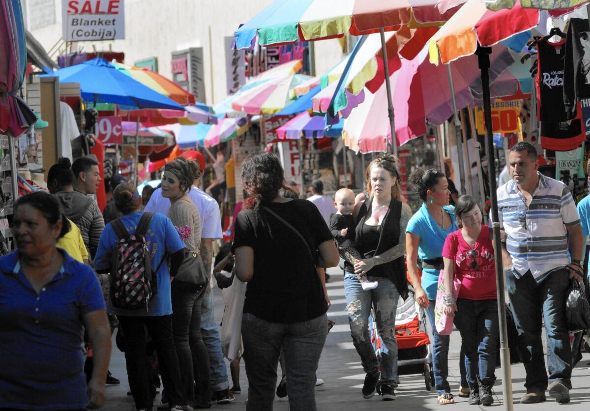 Shoppers search for deals along Santee Alley. Investigators found that 1,549 local garment workers were owed more than $3 million in unpaid wages -- an average of $1,900 per laborer.