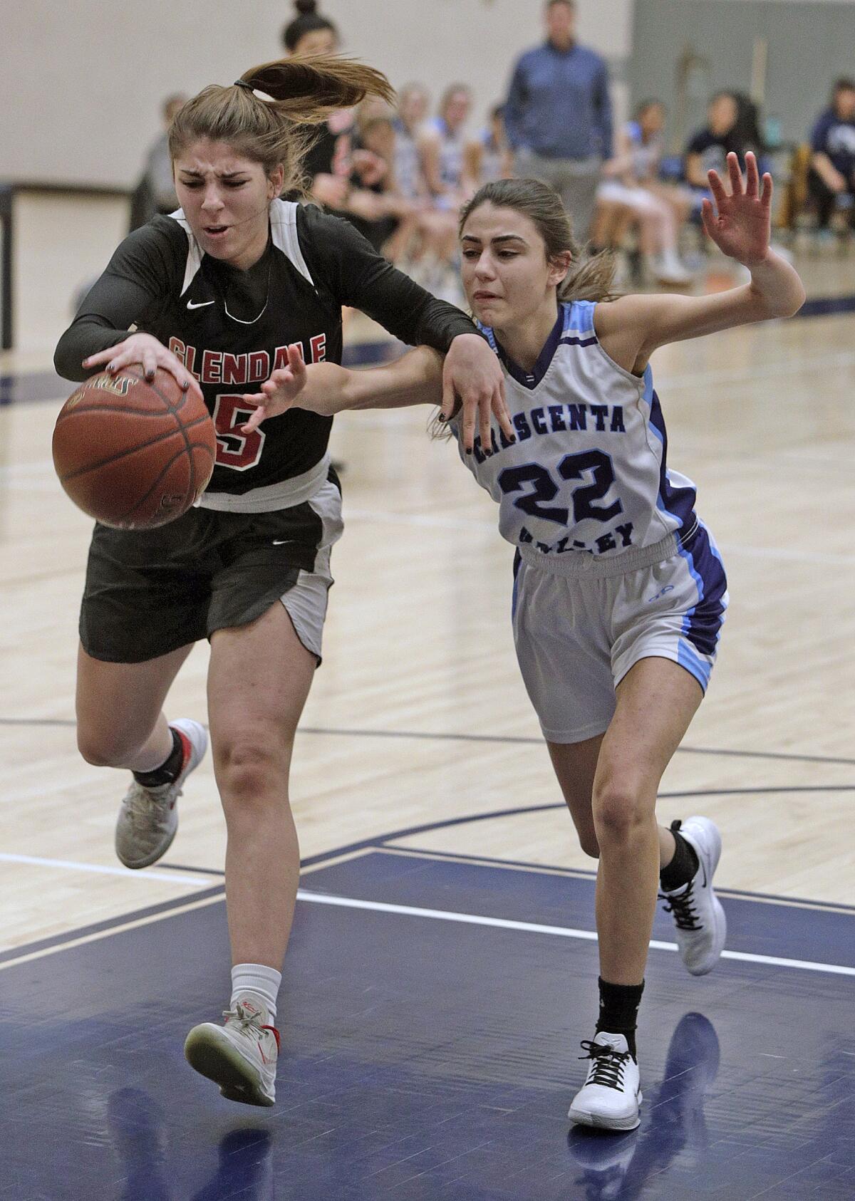 Glendale's Areco Orujyan reaches out for loose ball also being chased by Crescenta Valley's Katrina Minassian in a Pacific League girls' basketball game at Crescenta Valley High School on Tuesday, January 7, 2020.