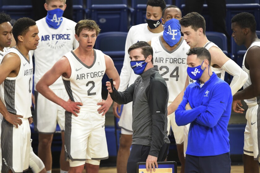 Air Force coach Joe Scott talks to his team during a timeout in the second half of an NCAA college basketball game against Utah State on Thursday, Dec. 31, 2020, at Air Force Academy, Colo. (Jerilee Bennett/The Gazette via AP)