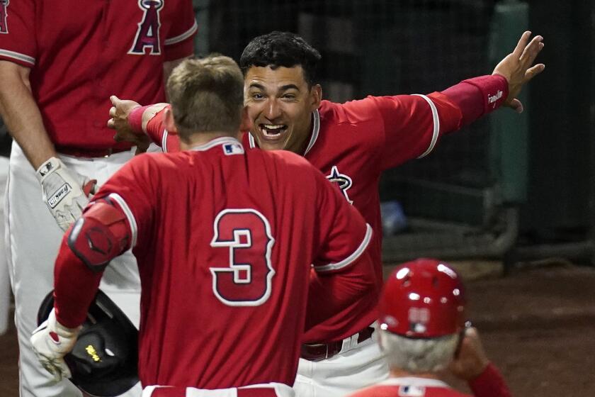 Los Angeles Angels' Taylor Ward, left, celebrates with Jose Iglesias after hitting a walk-off solo home run.
