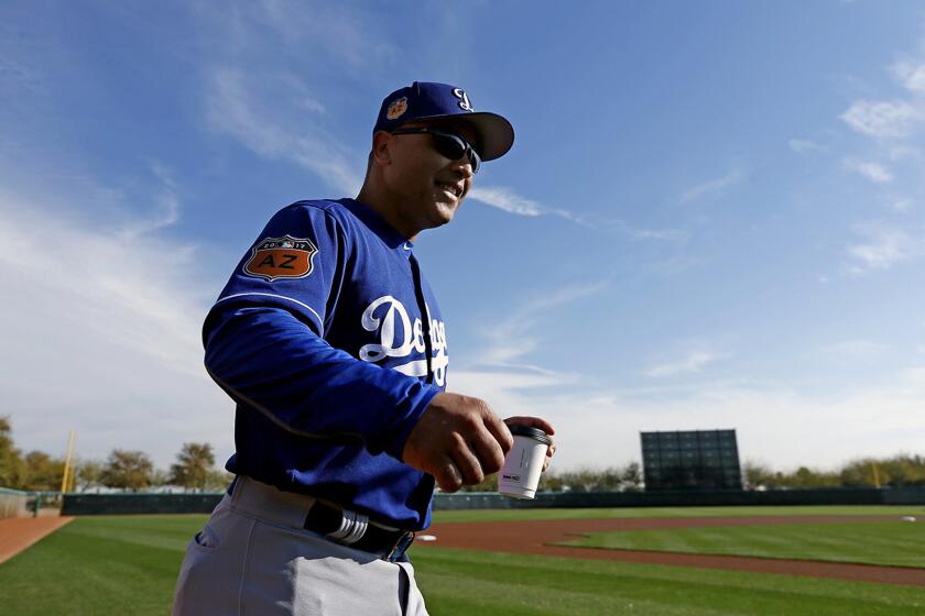 Dodgers Manager Dave Roberts arrives at the field for a spring-training practice at Camelback Ranch last month.