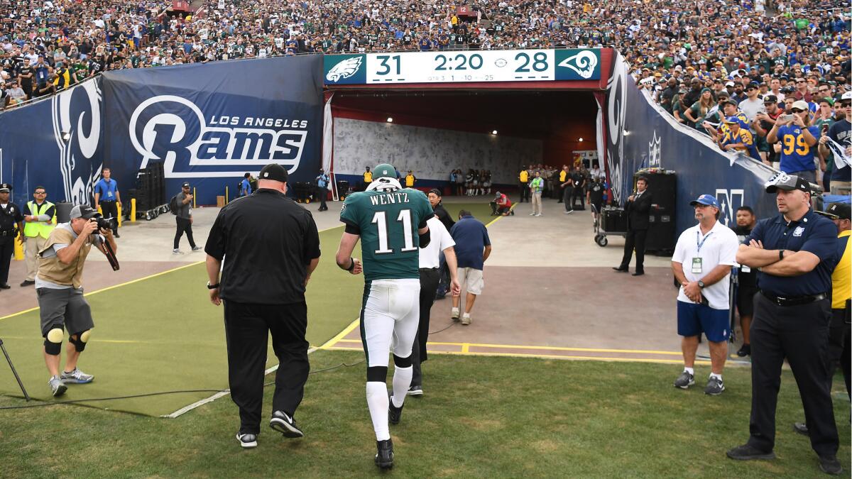 Eagles quarterback Carson Wentz walks off the field after suffering a torn ACL in his left knee against the Rams during the third quarter Sunday.