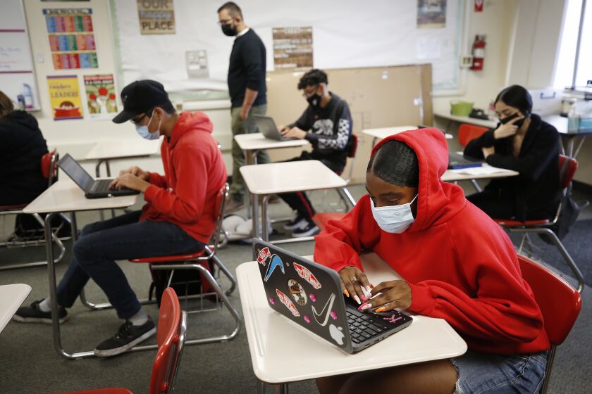 HAWTHORNE, CA - JULY 26: Kemani English, right, is masked in the English 2 class of teacher Adrian Sandoval, as students attend the last two day's of summer school at Hawthorne High School in the South Bays Centinela Valley Union High School District which didn't reopen in the spring, and instead reopened for in-person summer instruction. The students are finishing 5 weeks of the summer school session. Various summer schools are in session, and some districts see them as a trial run for the fall when it comes to protocols like distancing and masking mandates. Hawthorne High School on Monday, July 26, 2021 in Hawthorne, CA. (Al Seib / Los Angeles Times).