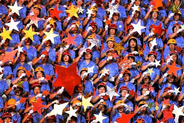 Participants perform a patriotic song in Beijing, where a concert drew people from all walks of life.