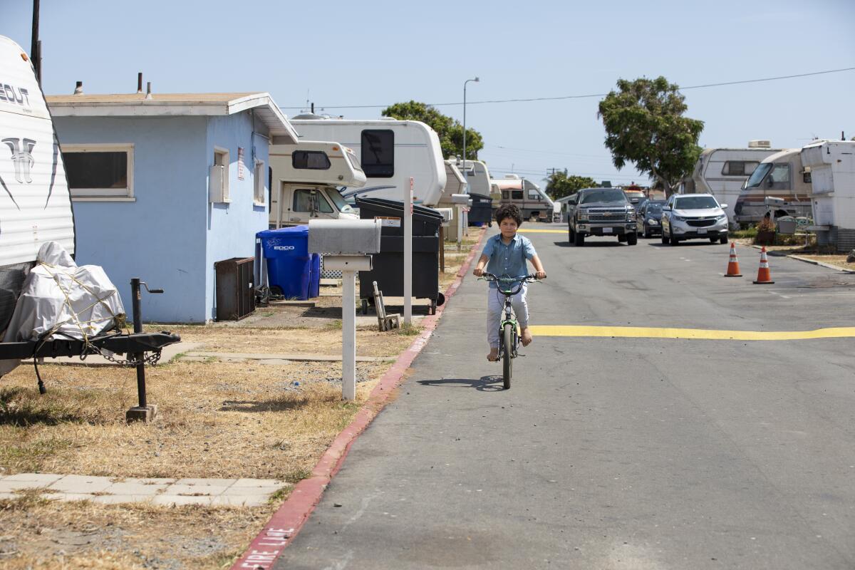 Dominic Nathaniel Orozco, 9, rides his bike down a street near his home.