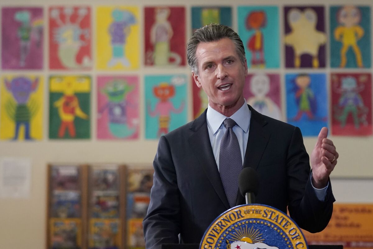 Gov. Gavin Newsom speaks at a news conference at James Denman Middle School in San Francisco, Friday, Oct. 1, 2021. California has announced the nation's first coronavirus vaccine mandate for schoolchildren. Newsom said Friday that the mandate won't take effect until the COVID-19 vaccine has received final approval from the U.S. government for various grade levels. (AP Photo/Jeff Chiu)