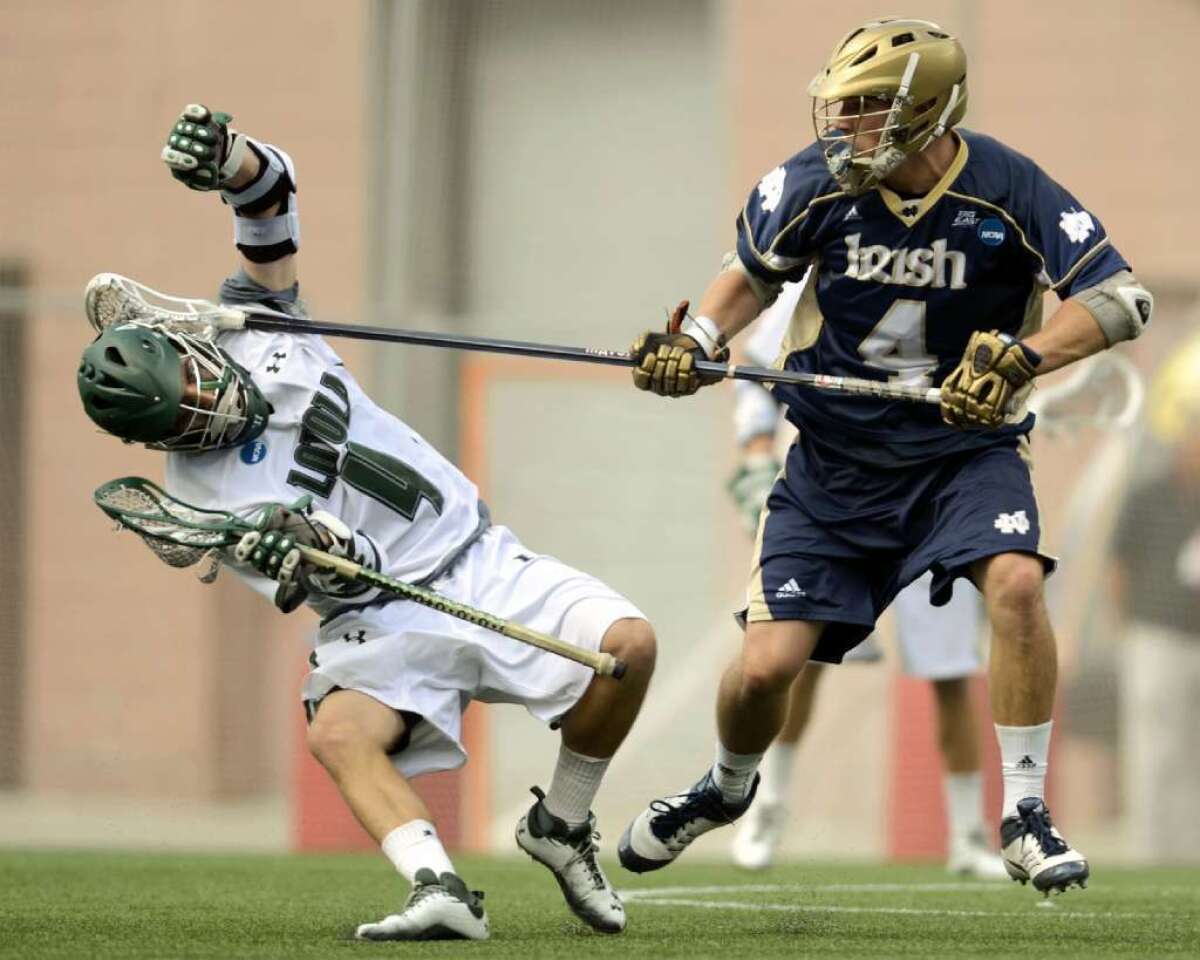 Loyola's Mike Sawyer, left, is slapped in the head by Notre Dame's Stephen O'Hara during a game on May 26, 2012.