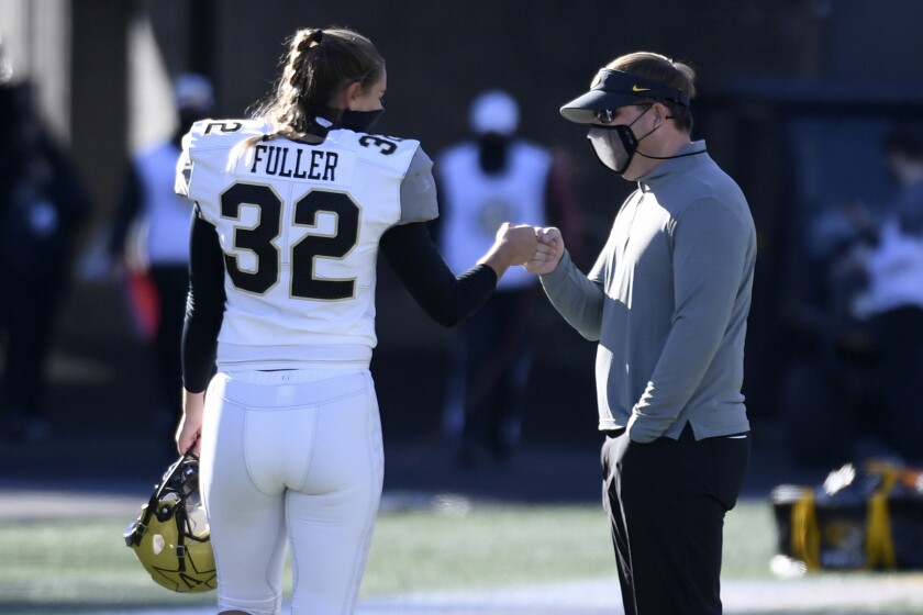 Vanderbilt place kicker Sarah Fuller (32) gets a fist-bump from Missouri head coach Eliah Drinkwitz after warming up before an NCAA college football game Saturday, Nov. 28, 2020, in Columbia, Mo. (AP Photo/L.G. Patterson)