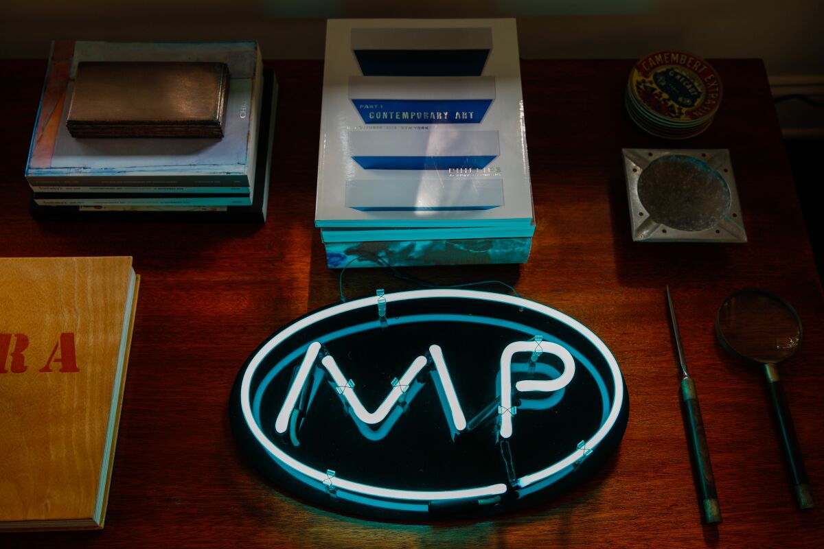 A neon sign with the initials for ’90s TV show "Melrose Place," in the home office of show creator Darren Star.