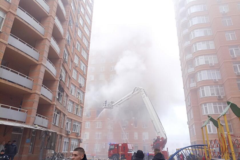 Firefighters work to extinguish a fire at a damaged apartment building after a Russian attack in Odesa, Ukraine, Friday, Dec. 29, 2023. (AP Photo/Artem Perfilov)