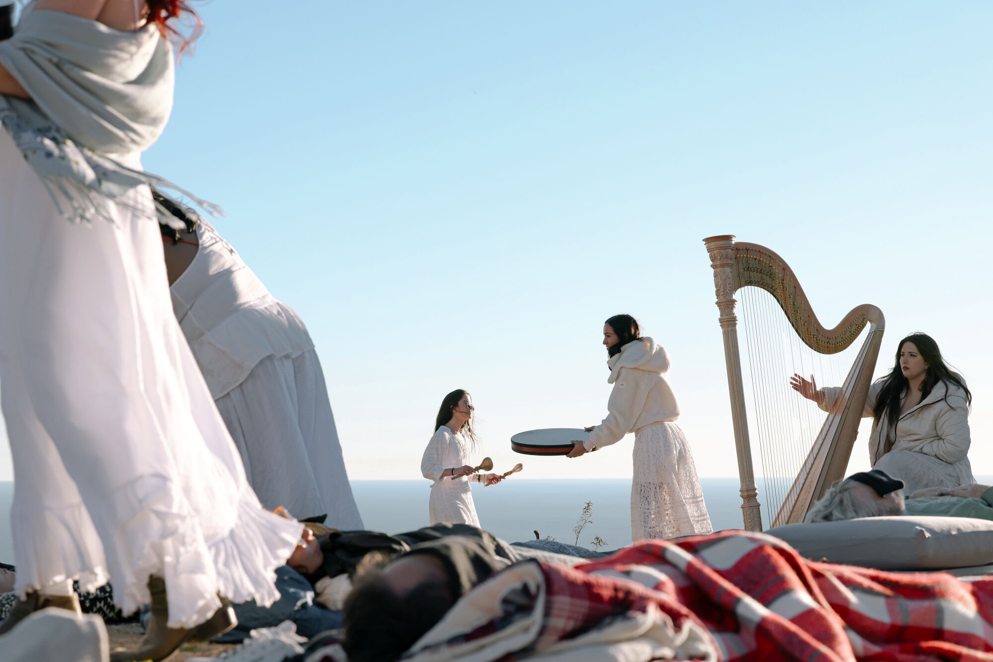At a sound bath, guests relax with pillows and blankets.