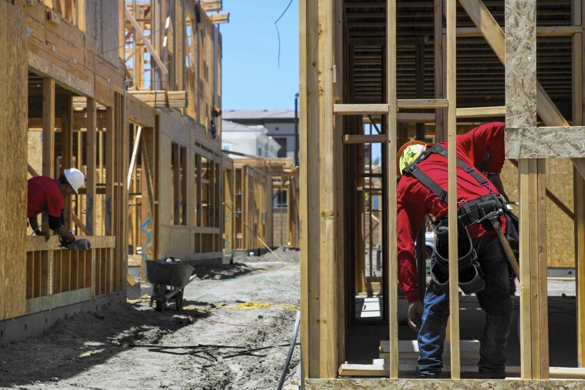New-home sales rose 6.8% in March to a seasonally adjusted annual rate of 517,000, the Commerce Department said last month. Prices also increased, reflecting higher demand and limited supplies. Above, workers at a new home development in Tustin.