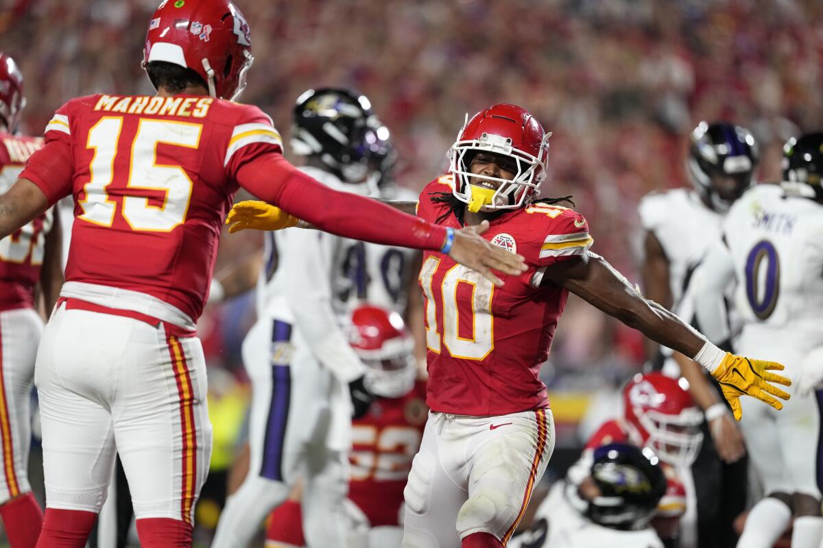 Kansas City Chiefs running back Isiah Pacheco, right, celebrates with quarterback Patrick Mahomes.