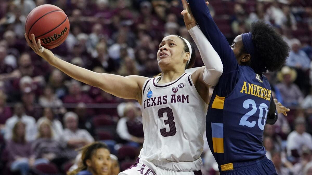 Texas A&M's Chennedy Carter drives for a layup against Marquette's Altia Anderson during the first half Sunday.