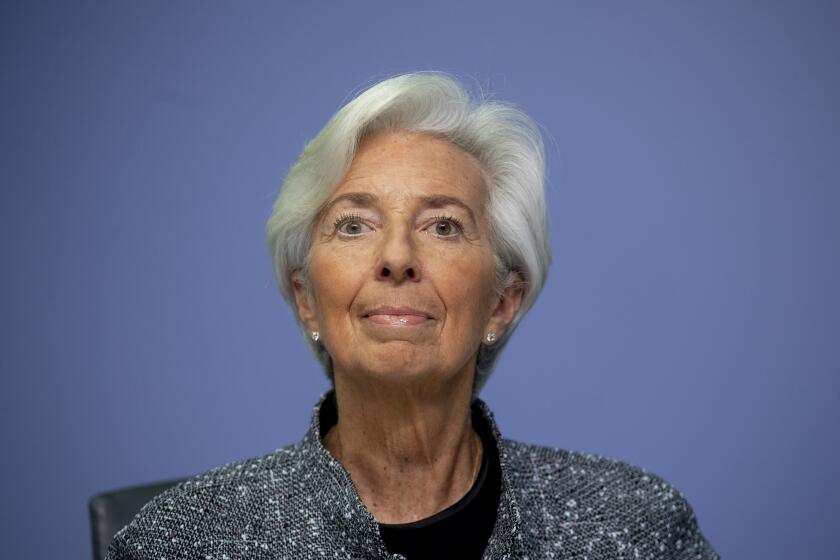 FILE -- In this Thursday, March 12, 2020 file photo the President of European Central Bank Christine Lagarde looks up prior to a press conference following a meeting of the ECB governing council in Frankfurt, Germany. The European Central Bank has boosted its pandemic emergency support program by 600 billion euros to 1.35 trillion euros ($1.5 trillion) in an effort to keep affordable credit flowing to the economy during the steep downturn caused by the virus outbreak. (AP Photo/Michael Probst, file)