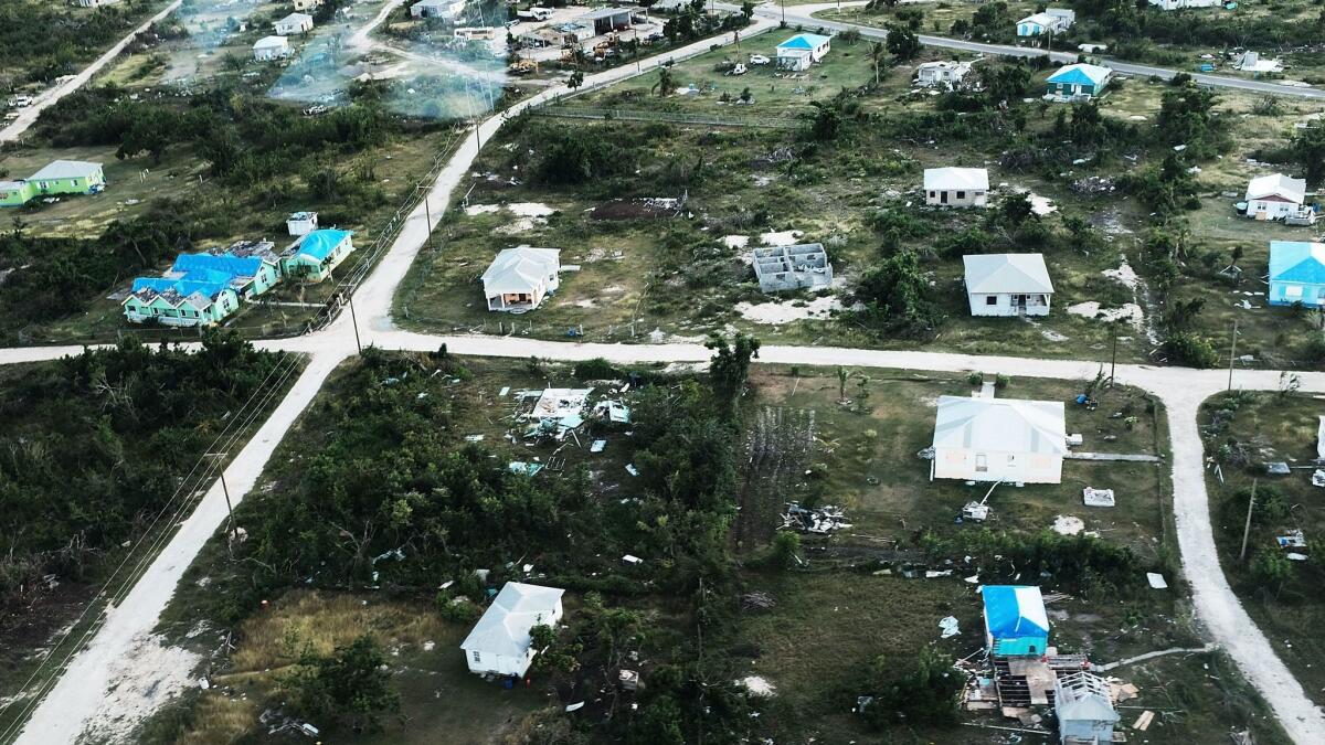 As hurricane recovery efforts continue, an aerial photo shows homes, some with restored roofs, in Codrington, Barbuda on Dec. 8.