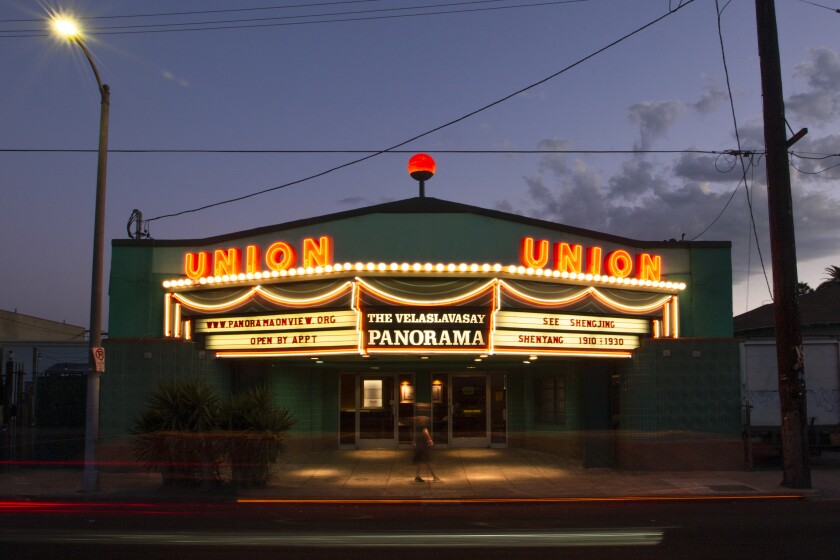 An old movie theater front that features a sign saying Velaslavasay Panorama.