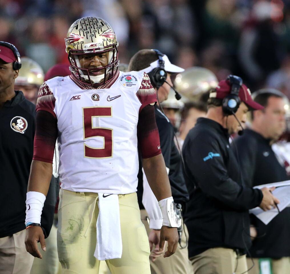 FSU quarterback Jameis Winston on the sideline with Coach Jimbo Fisher in the 4th quarter, as the Oregon Ducks runaway with the game, at the Rose Bowl, January 1, 2015. (Joe Burbank/Orlando Sentinel)
