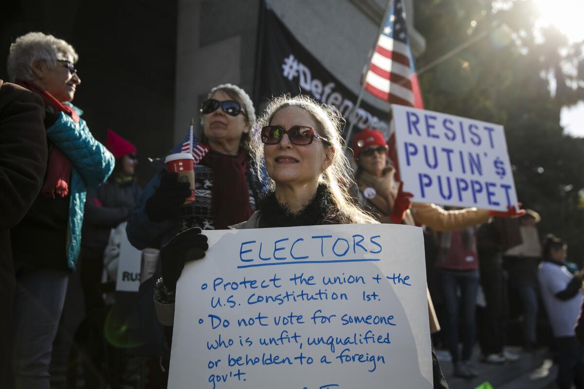 Protestors gather at the state Capitol in Sacramento before California's electors cast their ballots in the 2016 election.