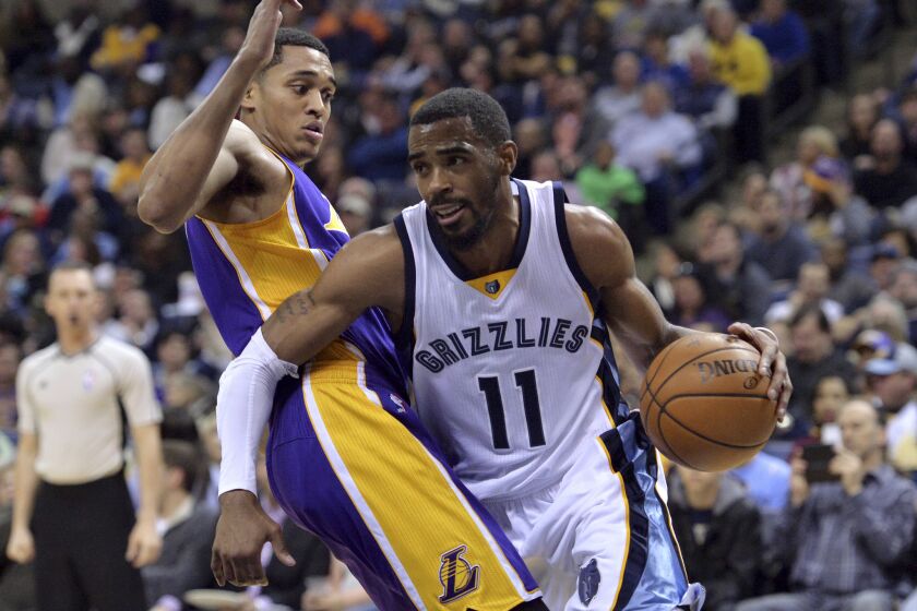 Grizzlies guard Mike Conley (11) drives against Lakers guard Jordan Clarkson during the second half on Wednesday.